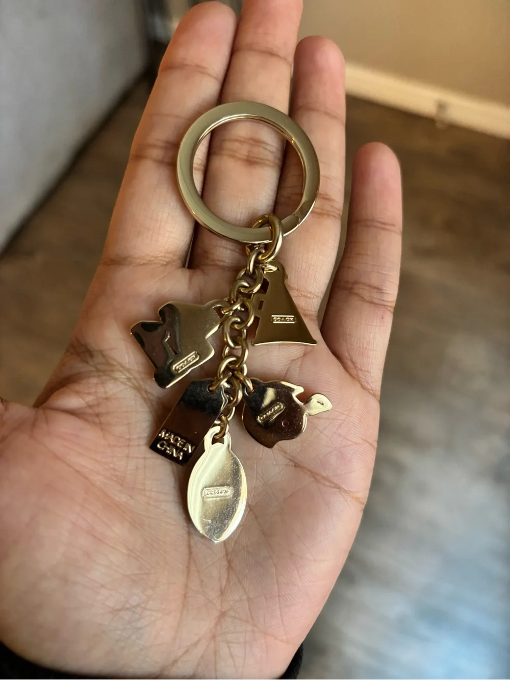 Coach Girly Football bag charm keychain in the champagne gold color